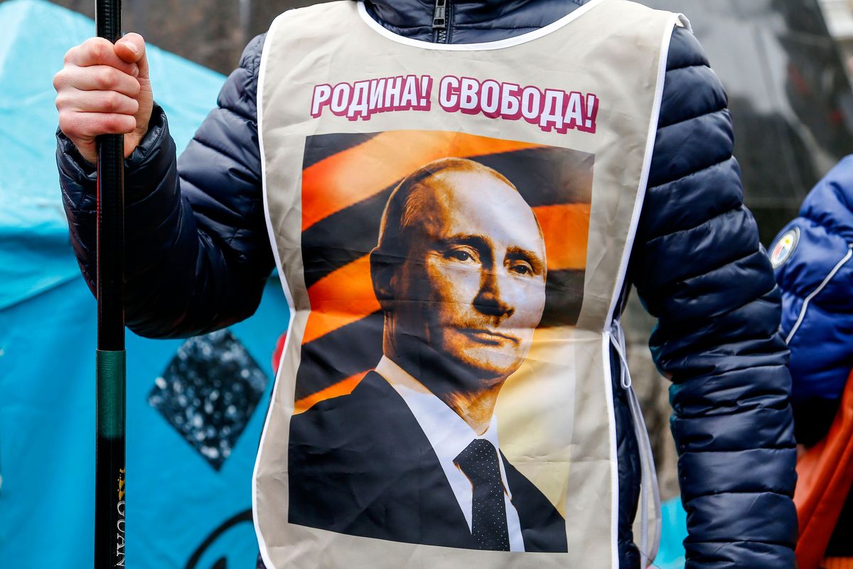 FILE – A pro-Russia demonstrator wears a vest bearing a depiction of Russian President Vladimir Putin and the words, “Motherland! Freedom!” during a rally in Donetsk, Ukraine, Sunday, March 16, 2014. Pro-Russia demonstrators in the eastern city of Donetsk called for a referendum similar to the one in Crimea.  (Andrey Basevich)