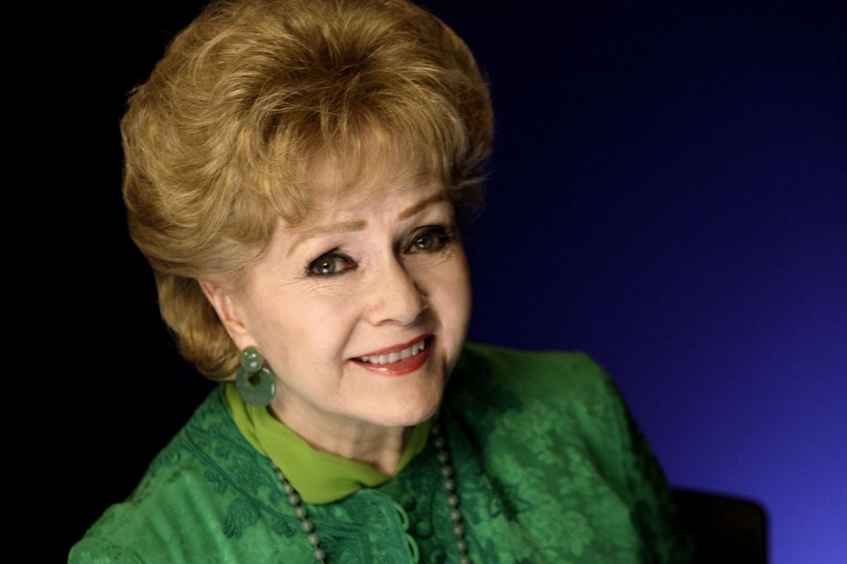 FILE - This Oct. 14, 2011 file photo shows actress Debbie Reynolds posing for a portrait in New York. The Los Angeles Times and celebrity website TMZ have reported that Reynolds has been rushed to the hospital Wednesday, Dec. 28, 2016, after suffering a medical emergency in Los Angeles one day after her daughter Carrie Fisher died. (Richard Drew / Associated Press)
