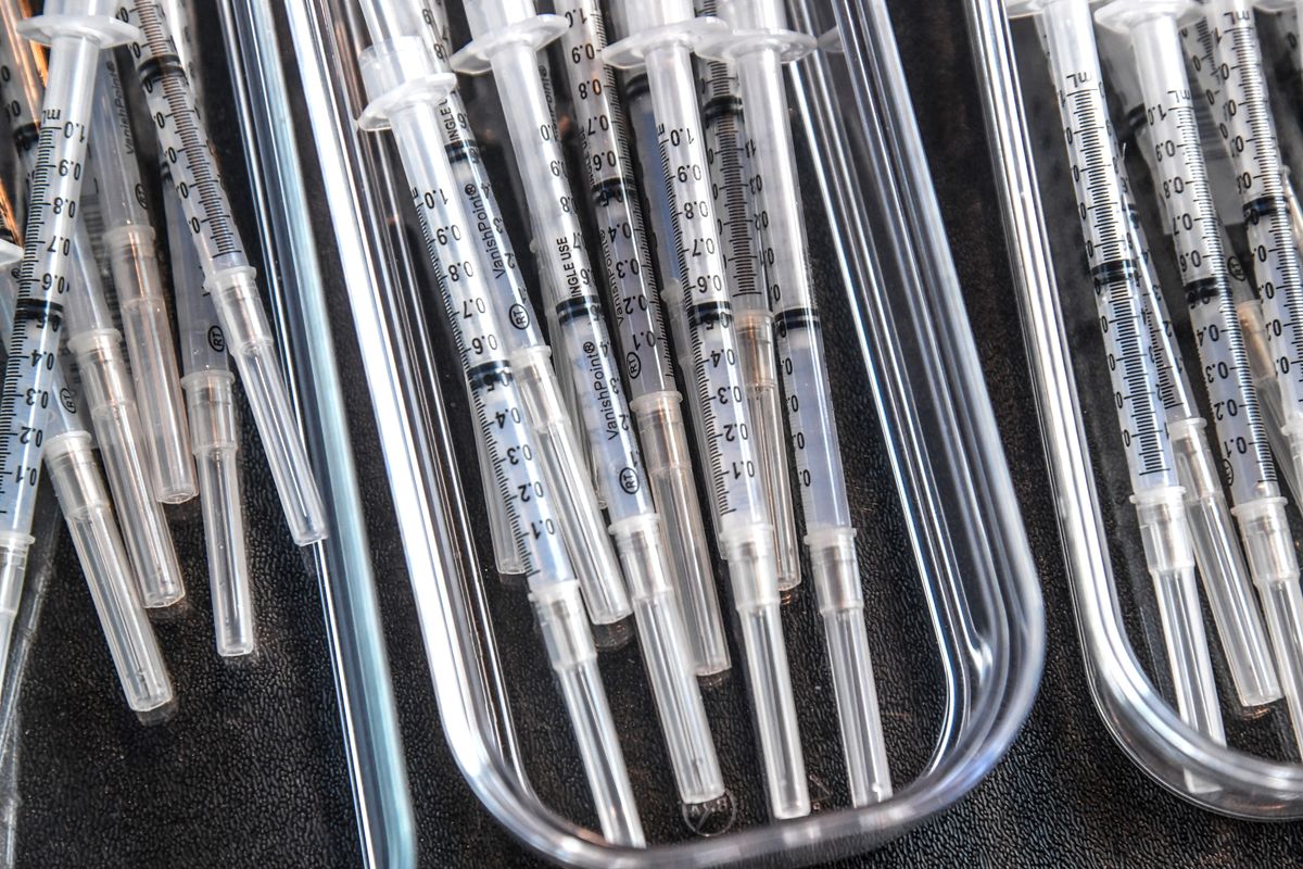 Syringes are filled with 0.05 mm of Moderna vaccine April 2 at the Spokane Arena. (DAN PELLE/THE SPOKESMAN-REVIEW)