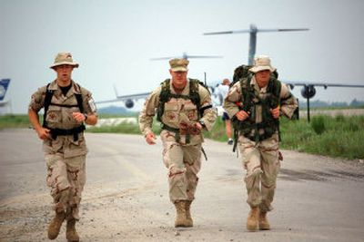 
From left, Airman 1st Class Sean Syck, Tech. Sgt. Brian Bartles and Staff Sgt. Michael Tyburski finished among the last but probably were the first to run a Bloomsday race in full military uniform with 50-pound rucksacks. 
 (Photo couresty of Air Force Staff Sgt. Lara Gale / The Spokesman-Review)