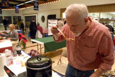 
Bill Livingstone assesses the progress of his chili shortly before tasting began at last year's  Sandpoint Winter Carnival chili cook-off at the Bonner Mall. 
 (File / The Spokesman-Review)