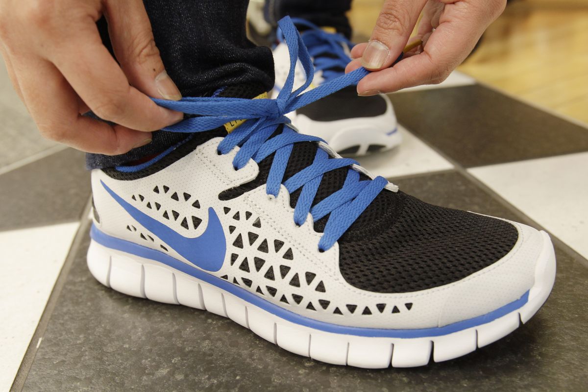 FILE - In this March 15, 2011 photo, a customer ties a Nike's Livestrong shoe, which supports the Lance Armstrong Foundation, at a shoe store in San Francisco.  Nike forgave a contrite Tiger Woods after his infidelity was exposed. It welcomed back an apologetic Michael Vick once he served time for illegal dog-fighting. But the company dropped Lance Armstrong, Wednesday, Oct. 17, 2012, faster than the famed cycler could do a lap around the block. (Associated Press)