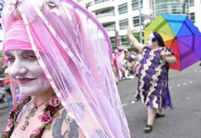 
Participants walk during the gay pride parade on Sunday in Seattle. Thousands of people lined the parade route.Associated Press
 (Associated Press / The Spokesman-Review)