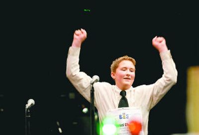 
Gabriel Cheeley raises his arms in victory after correctly spelling 