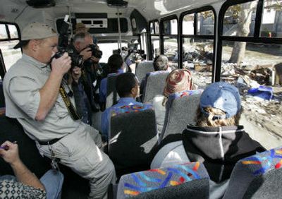 
News photographers photograph tourists Wednesday during a tour of flood-ravaged New Orleans. 
 (Associated Press / The Spokesman-Review)