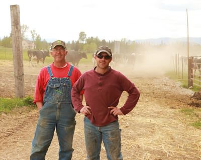 Randy Poelstra, left, and his son, Garrett, pose at the family’s dairy farm. (Associated Press)