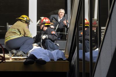 Spokane Fire Department personnel secure the body of a man who fell from the west side of the Parkade in Spokane on Wednesday.  (CHRISTOPHER ANDERSON / The Spokesman-Review)