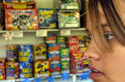 
Coeur d'Alene Tribe member Corrina Hendrickx, 19, sells fireworks at Indian Country Fireworks near Worley on Tuesday. 
 (Kathy Plonka / The Spokesman-Review)