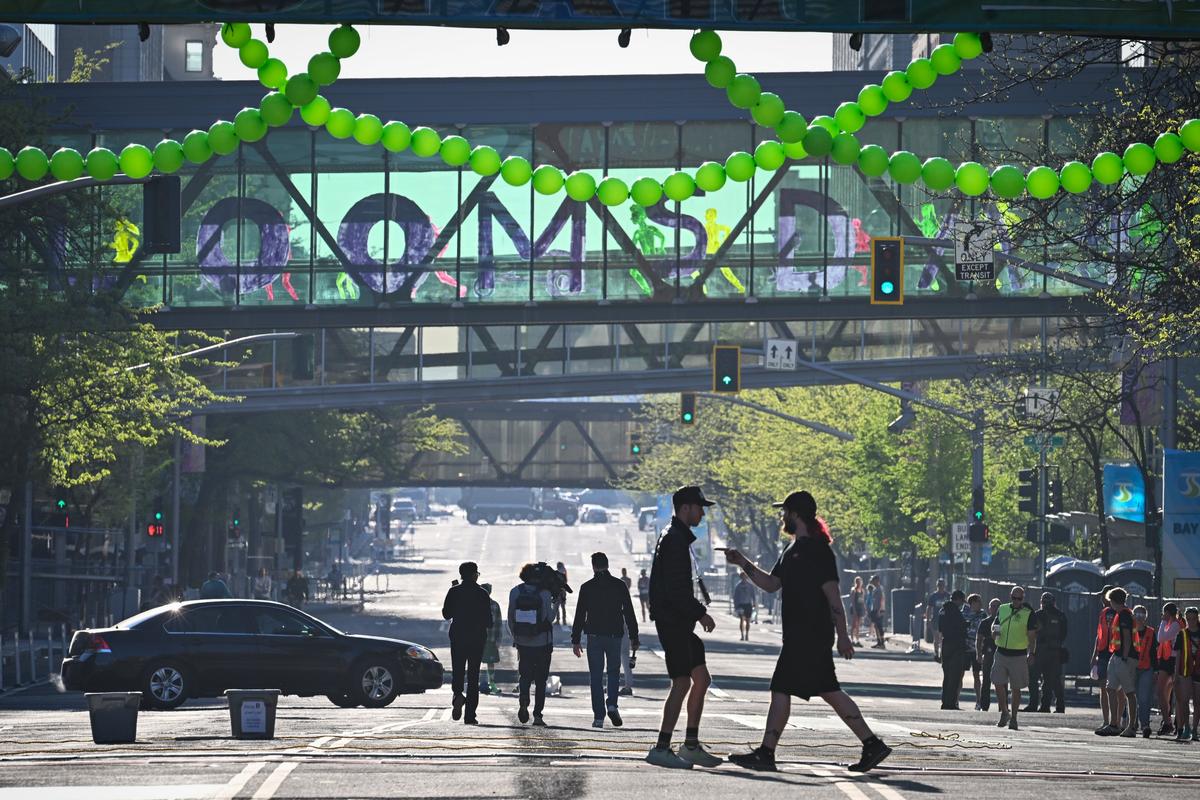 Bloomsday volunteers gather on early Sunday morning on empty Riverside Avenue before the crowds arrive, May 3, 2026 in Spokane.  (Dan Pelle/For the Spokesman-Review)