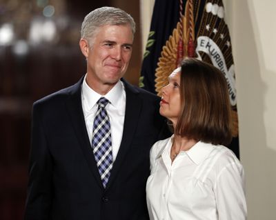 Judge Neil Gorsuch stands with his wife, Marie Louise Gorsuch, as President Donald Trump announces him as his choice for the Supreme Court in the East Room of the White House in Washington in January 2017. Somewhere between the Republican caricature of the next justice of the Supreme Court as a folksy family guy and the Democrats’ demonization of him as a cold-hearted automaton, there stands Neil Gorsuch. (Carolyn Kaster / File/Associated Press)