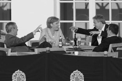 
From left, President  Bush, German Chancellor Angela Merkel, British Premier Tony Blair and Italian Prime Minister Romano Prodi enjoy a cold drink on the patio Thursday in Heiligendamm, Germany. 
 (Associated Press / The Spokesman-Review)