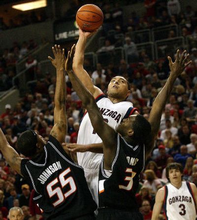 
Gonzaga center J.P. Batista shoots over the Oklahoma State defense Saturday in Seattle. 
 (Brian Plonka / The Spokesman-Review)