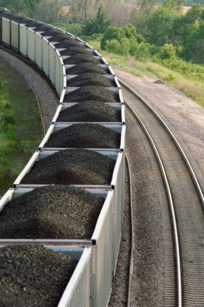 Freight trains loaded with coal head down railroad tracks. In the ongoing discussion of what to do with coal, one proposal that involves shutting down a coal plant in Washington is to instead ship coal from Montana west through Spokane to ports like Vancouver and Bellingham.  (Thinkstock Images / Photos.com)