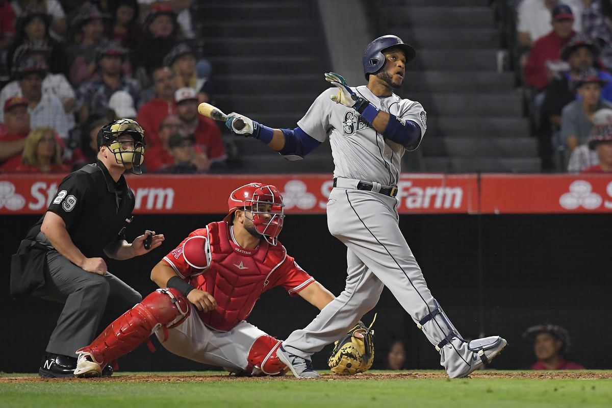 Robinson Cano  hits a three-run home run  during the fifth inning, his first of two on the night. Cano finished 3 for 5 with five RBIs. (Mark J. Terrill / Associated Press)