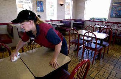 
It's lunchtime on a Wednesday afternoon and Kayla Smith cleans the tables in a nearly empty Kentucky Fried Chicken at 9512 East Sprague. 
 (Liz Kishimoto / The Spokesman-Review)