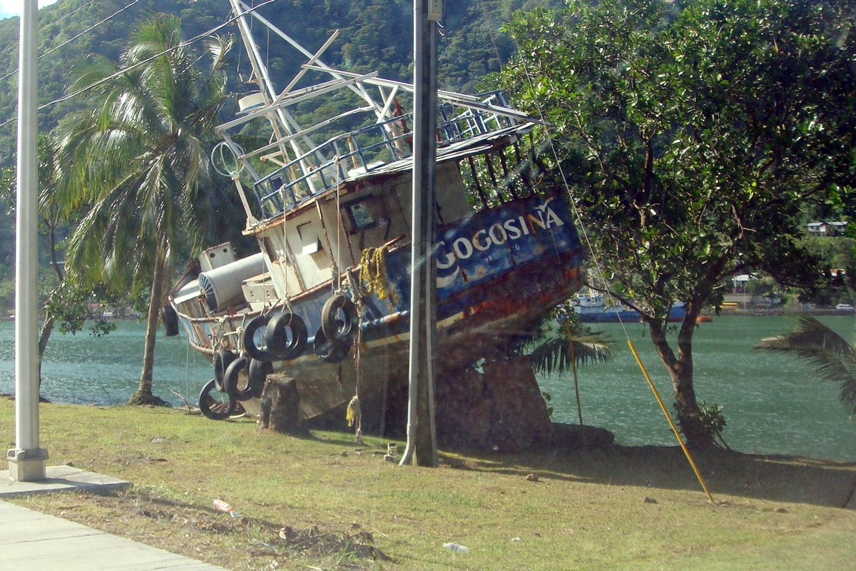 This photo taken Tuesday, Sept. 29, 2009, shows the fishing boat "Gogosina" on Beach Road in Pago Pago, American Samoa. A magnitude 8.0 quake struck early Tuesday morning, and sent giant waves crashing down on the islands. "Gogosina" is the Samoan word for the seabird also known as a tern.  (AP Photo/Bruce Leiataua) (Bruce Leiataua / Associated Press)