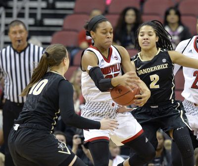 Louisville guard Asia Durr (25) grabs the ball between the defense of Vanderbilt guard Cierra Walker (10) and Chelsie Hall during the first half of an NCAA college basketball game, Thursday, Dec. 7, 2017, in Louisville, Ky. (Timothy D. Easley / Associated Press)