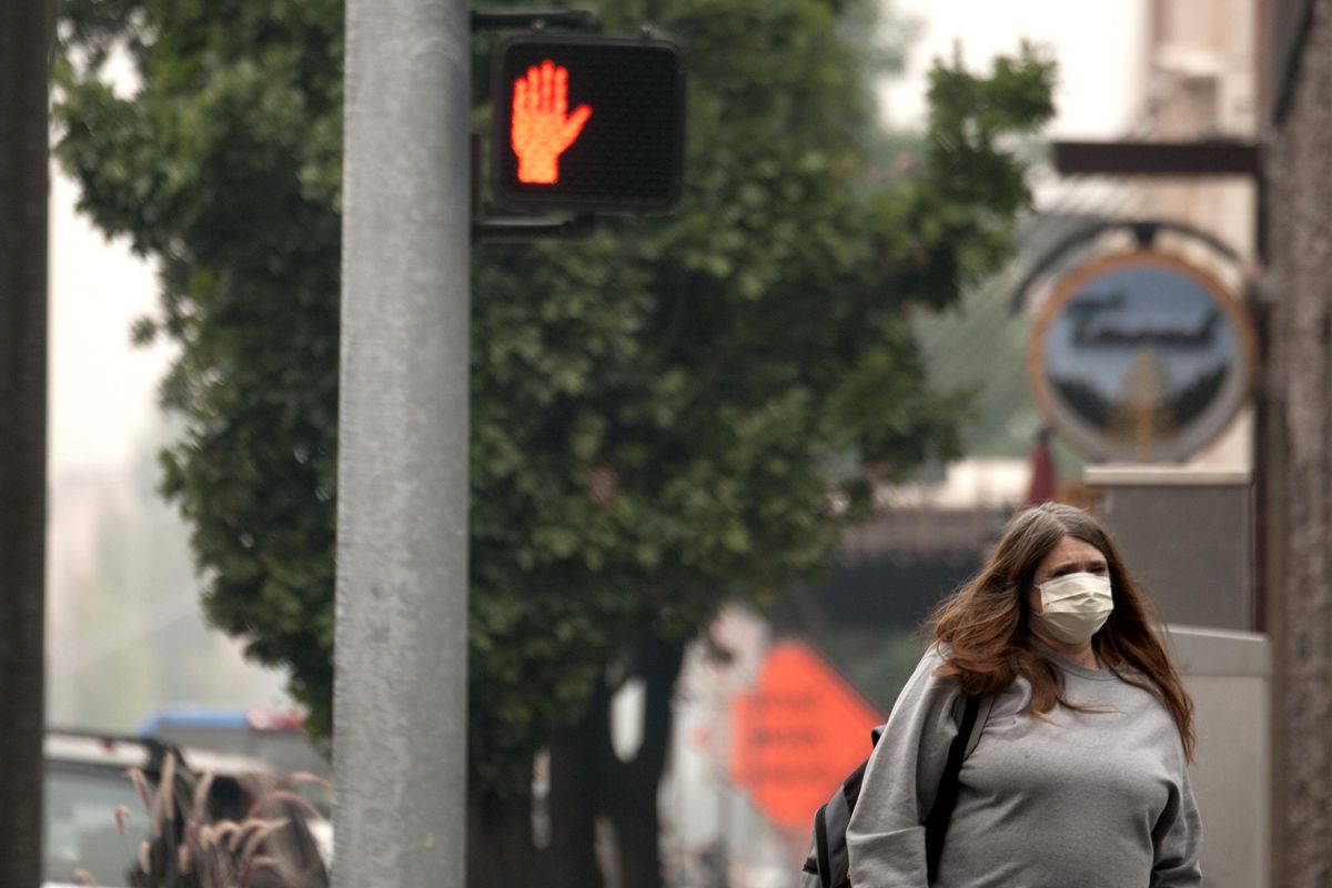 "I've had a headache for two days now," said Debbie Sims as she walked through a smokey downtown Spokane on Tuesday, Sept. 5, 2017. (Kathy Plonka / The Spokesman-Review)