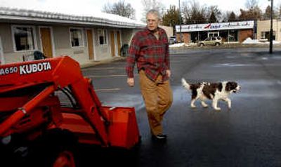 
Norman Paul, owner of the State Motel in Coeur d'Alene, traveled to California  to pick up a small tractor so he could move snow from his motel parking lot.  He opted for his own tractor after paying others to clear the snow. 
 (Kathy Plonka / The Spokesman-Review)