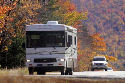 
A Winnebago recreational vehicle is driven through Crawford Notch State Park, N.H. Winnebago Industries Inc.'s fourth-quarter earnings surged 59 percent, a reflection of increased sales of its larger and higher profit motor homes. Associated Press
 (FILE Associated Press / The Spokesman-Review)