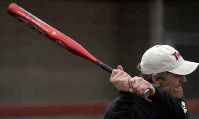
University High softball coach Don Owen uses a metal bat during an after-school drill with the team. 
 (Liz Kishimoto / The Spokesman-Review)