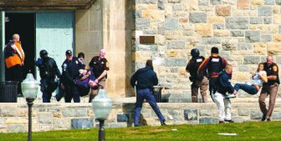 
Police remove the wounded from Norris Hall, where a gunman killed 30 people Monday morning on the campus of Virginia Tech. 
 (Alan Kim The Roanoke Times / The Spokesman-Review)