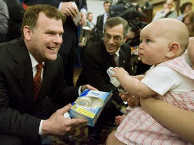 
Canadian Environment Minister John Baird, left, and Health Minister Tony Clement hand out BPA-free bottles to 5-month-old Georgia Symondson on Friday in Ottawa. Associated Press
 (Associated Press / The Spokesman-Review)