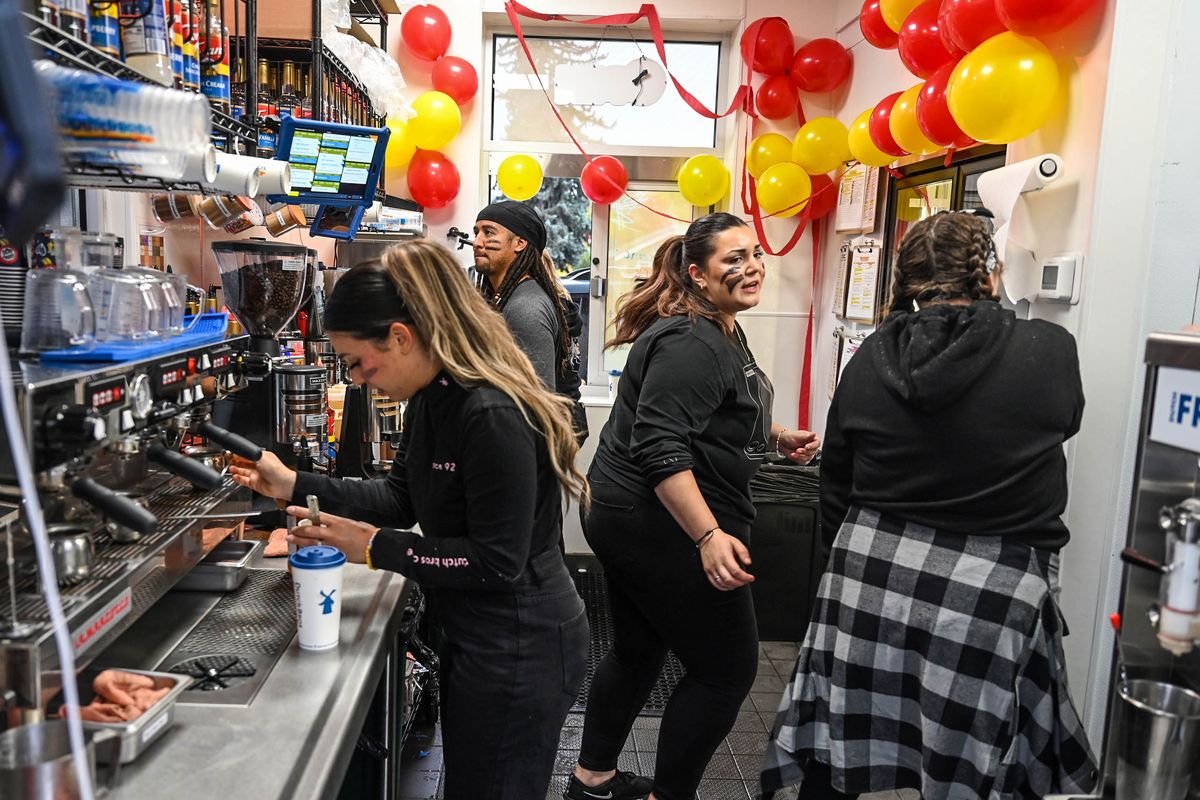 Dutch Bros employees scramble to fill orders Wednesday morning. Customers returned to the rebuilt coffee stand for the first time after a dump truck crashed into the former Dutch Bros, destroying the South Freya Street location on Aug. 20, 2021.  (DAN PELLE/THE SPOKESMAN-REVIEW)