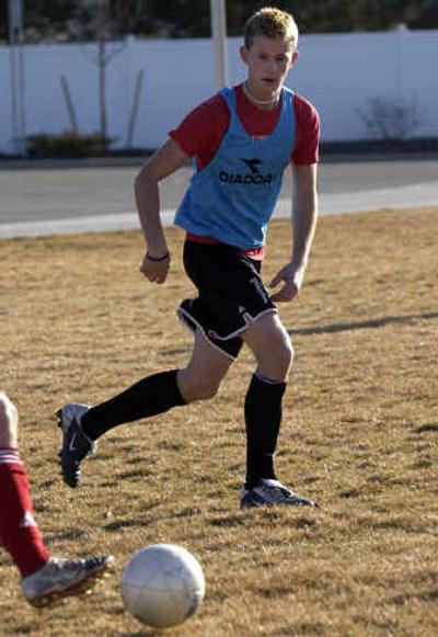 CV's Brady Coyle keeps a eye on the ball during an after-school practice. Below, CV soccer coach Brandon Deyarmin, right, has led the boys team to its first state tournament in history. 
 (Photos by Liz Kishimoto/ / The Spokesman-Review)