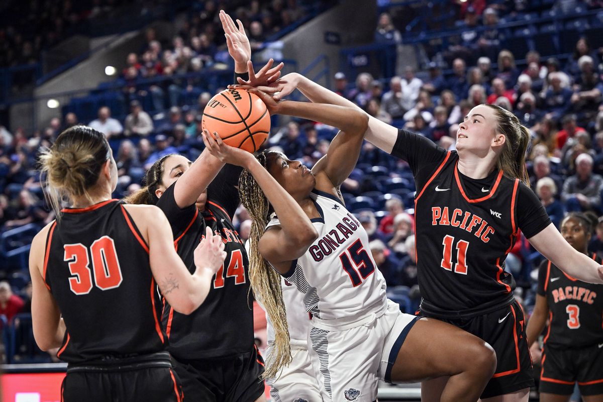 Gonzaga forward Yvonne Ejim (15) is swarmed by Pacific guard Sam Ashby (30) center Elizabeth Elliott (14) and forward Cecilia Holmberg (11) as she tries to shoot the ball during the second half of a NCAA college basketball game, Thursday, Feb. 16, 2023, in the McCarthey Athletic Center.  (COLIN MULVANY/THE SPOKESMAN-REVIEW)