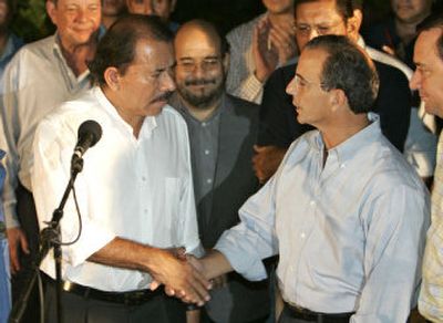 
Nicaraguan President-elect Daniel Ortega, left, shakes hands with his rival, Eduardo Montealegre, after Montealegre paid a courtesy visit to Ortega's headquarters in Managua on Tuesday. 
 (Associated Press / The Spokesman-Review)