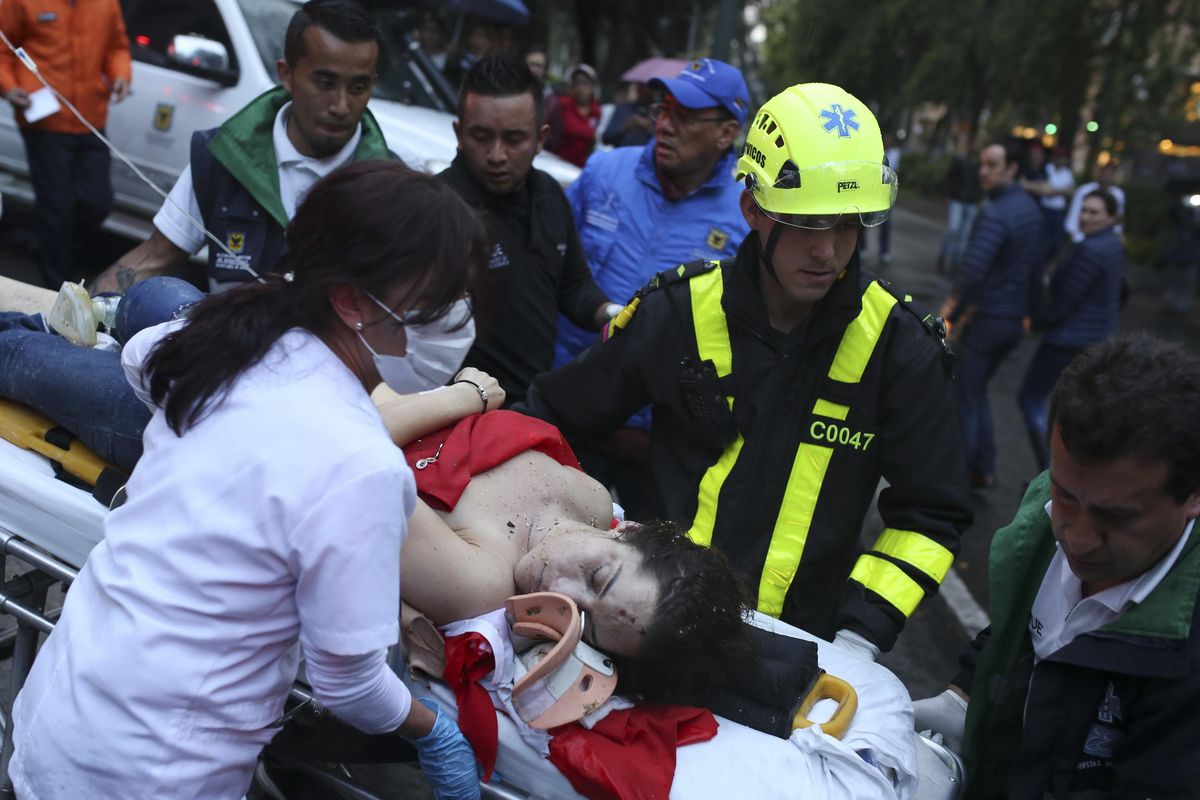 An injured woman is evacuated on a gurney after an explosion at the Centro Andino shopping center in Bogota, Colombia, Saturday, June 17, 2017. Authorities reported at least 3 persons killed with scores more injured. (Ricardo Mazalan / Associated Press)