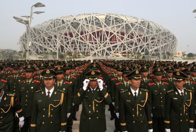 Chinese paramilitary police officers prepare to take an oath to ensure safety during the 2008 Beijing Olympics, in a drill outside National Stadium in Beijing, China, on Wednesday.  (Associated Press / The Spokesman-Review)