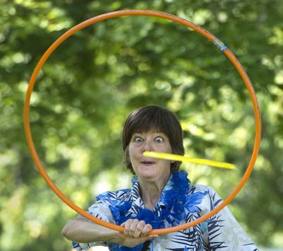 Eyes on target: Catherine Cooper, Avista Corp.’s Commute Trip Reduction coordinator, tries to catch a flying disc through her hoop during the company’s lunch-hour health and wellness activities Wednesday at Mission Park in Spokane. (Dan Pelle)