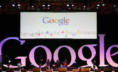 
Chinese youth sit on a Google sign shortly after Google debuts its Chinese language brand name in the Beijing Hotel in Beijing, China. 
 (Associated Press / The Spokesman-Review)