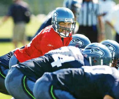 
Seahawks quarterback Seneca Wallace glances down the line during a July 2003 drill at the team's training camp at Eastern Washington University. 
 (File/Associated Press / The Spokesman-Review)