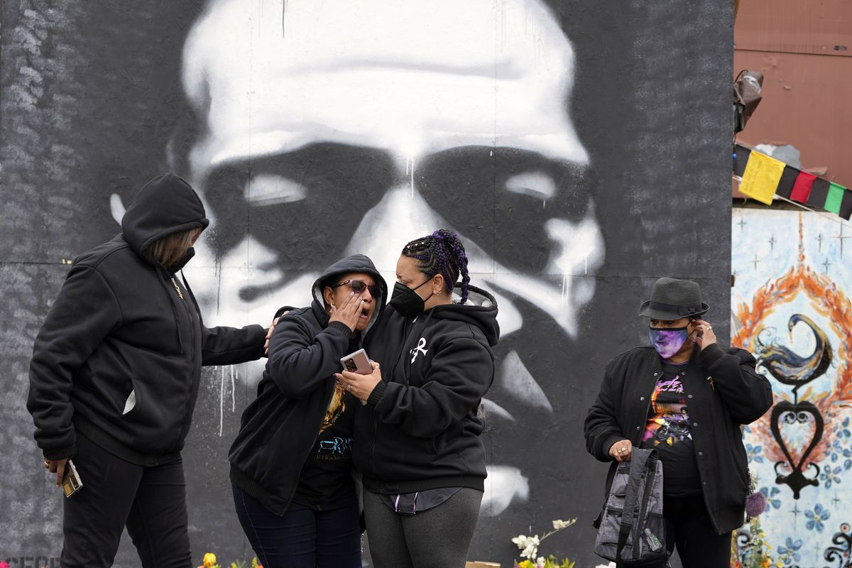 A group of women from Colorado and North Carolina react while paying respects to George Floyd at a mural at George Floyd Square on Friday in Minneapolis.  (Julio Cortez/Associated Press)