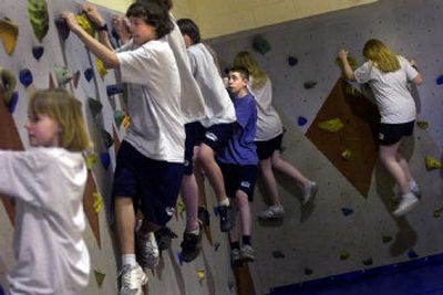 Students at Glover Middle School get a workout on a climbing wall in the school's gym. Spokane Public Schools is trying to introduce activities that children can do for life.
(Jed Conklin / The Spokesman-Review)