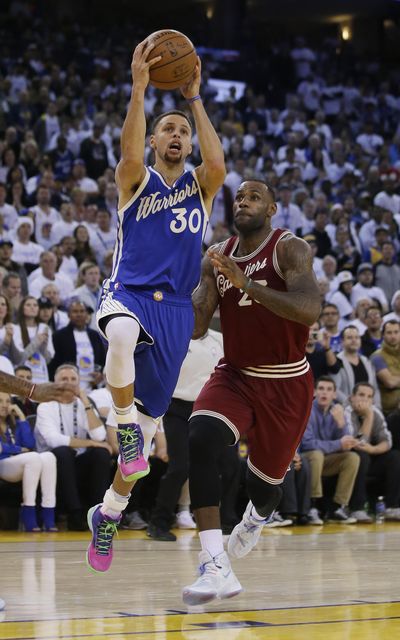 Golden State Warriors' Stephen Curry (30) drives past Cleveland Cavaliers' LeBron James during the second half of game Friday. (Marcio Sanchez / Associated Press)