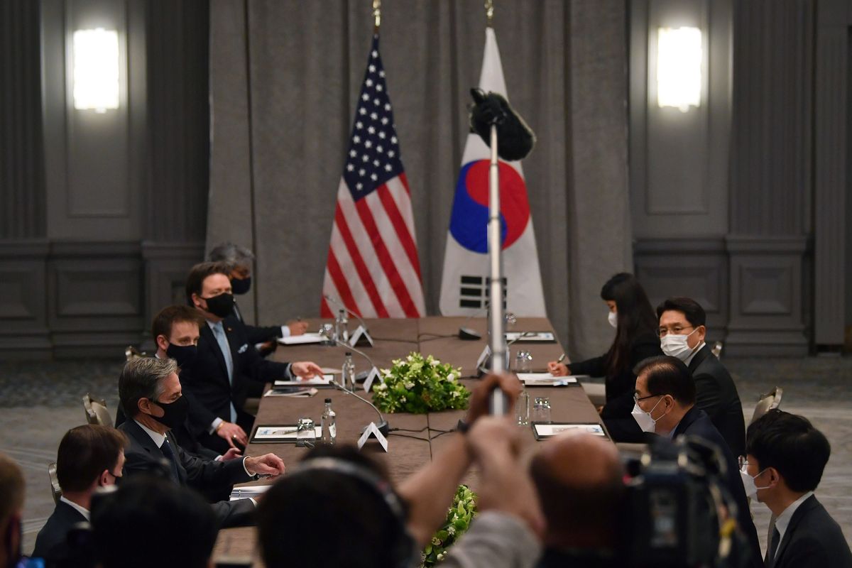 United States Secretary of State Antony Blinken, second left, wearing a face mask to curb the spread of coronavirus, speaks to South Korea