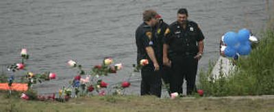 
Bridgeport, Conn., police  confer Thursday  near  the pond  a van rolled into  Wednesday, killing a woman, her son and a  friend. A nephew pulled from the van died Thursday.Associated Press
 (Associated Press / The Spokesman-Review)