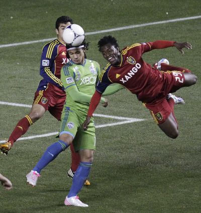 Salt Lake midfielder Kenny Mansally, right, heads the ball in front of Sounders forward Fredy Montero. (Associated Press)
