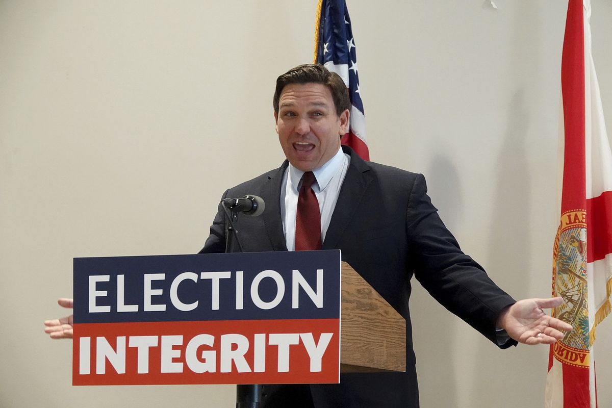 FILE - Florida Gov. Ron DeSantis asks the crowd "How about Virginia," as he arrives at an event in West Palm Beach, Fla., to announce proposed election reform laws, Wednesday, Nov. 3, 2021. Republicans promoting claims of widespread voter fraud in at least two politically important states are turning to a new tactic to appease voters who falsely believe the 2020 presidential election was stolen: election police. The efforts in Florida and Georgia to establish law enforcement units dedicated to investigating voting or election crimes come as Republican lawmakers and governors move to satisfy the millions of voters in their party who believe former President Donald Trump’s false claims that widespread voter fraud cost him re-election.  (Joe Cavaretta)