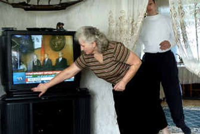 
Lidiya Medvedev, of Spokane, turns up the Russian satellite news report about Kyrgyzstan's new regime, and her son Sergey comes out to watch with the rest of the family in Spokane Tuesday. 
 (Holly Pickett / The Spokesman-Review)