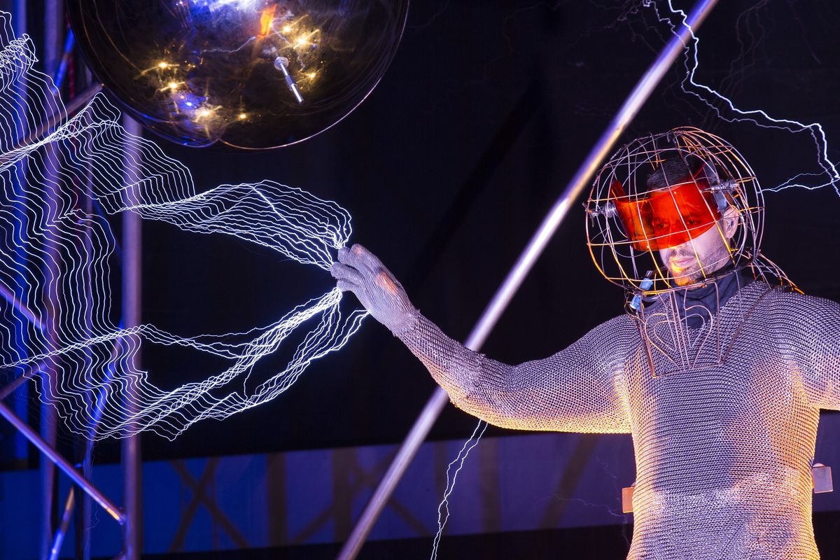 David Blaine stands inside an apparatus surrounded by a million volts of electric currents. (Associated Press)
