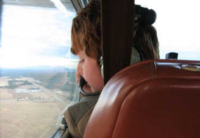 Grant Mason, 10, of Coeur d'Alene looks down during a flight with the SOARING program.
(Noah Buntain / The Spokesman-Review)