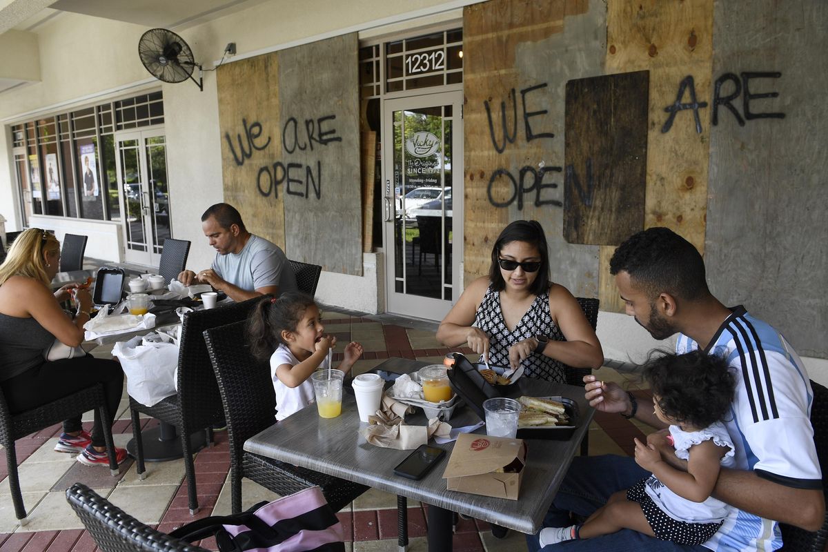 Gesso Pineda feeds a croquet to his daughter, Aria, as they have breakfast with his wife, Elba, and older daughter, Sofia, at Vicky Cafe, Friday, Sept. 8, 2017 in Miramar, Fla. Irma took direct aim at Florida on Friday and officials ordered evacuations for at least 1.4 million people along the Southeastern coast, as the monstrous Category 4 hurricane spun toward a path that forecasters have long feared: Right through the heart of the peninsula. (Taimy Alvarez / Associated Press)