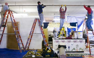 From left to right, Jason McLenithan, Chris Nelson, Cal Ryen and Don Maak install sprinkler pipes at the Truth Ministries homeless shelter Saturday morning. Two dozen pipe fitters from Local 669 Sprinkler Fitters Union donated their skills, materials and labor to help Truth Ministries comply with fire codes so that the shelter can reopen.
(Photos by Holly Pickett/ / The Spokesman-Review)