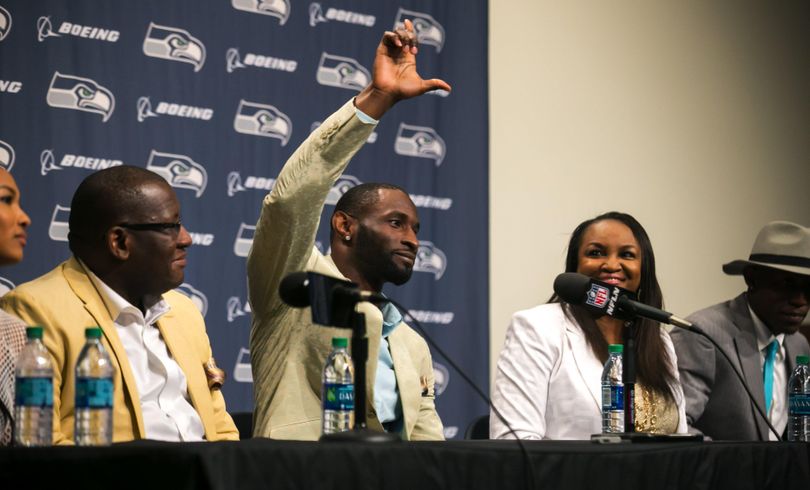 Ricardo Lockette, surrounded by his family, has no regrets after retiring from the Seattle Seahawks because of an injury suffered last season. (Bettina Hansen / Associated Press)