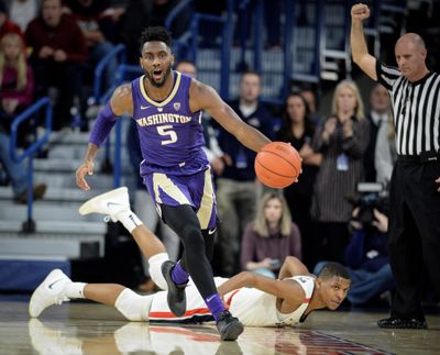 Washington’s Jaylen Nowell dribbles downcourt as Gonzaga’s Zach Norvell Jr. watches on the ground during the Zags’ 81-79 home win  on Wednesday  at the McCarthey Athletic Center.